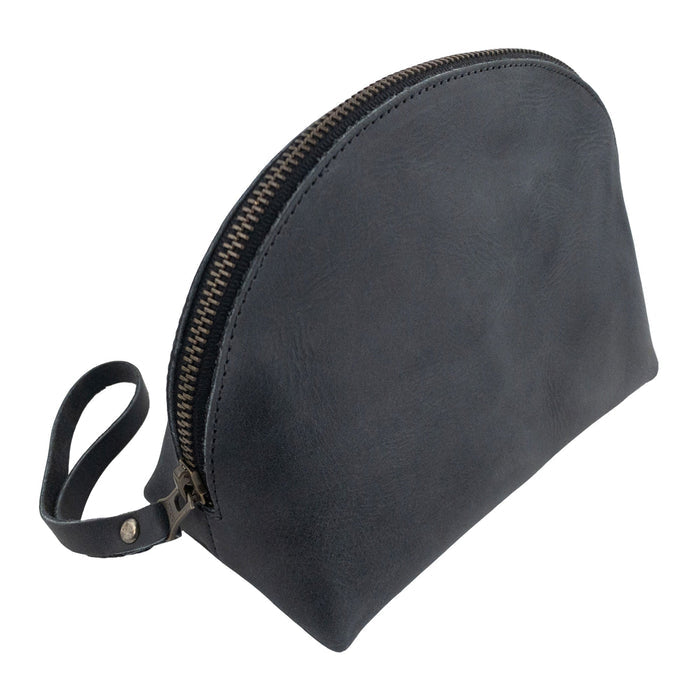 Side profile of the Accessory Pouch Organizer Hand Bag by Hide & Drink in beautiful black leather. This Cosmetic Travel Organizer with Hand Strap for Women doubles as a Makeup Bag and Classic Handbag, showcasing artisan craftsmanship from La Antigua Guatemala & Oaxaca Mexico.