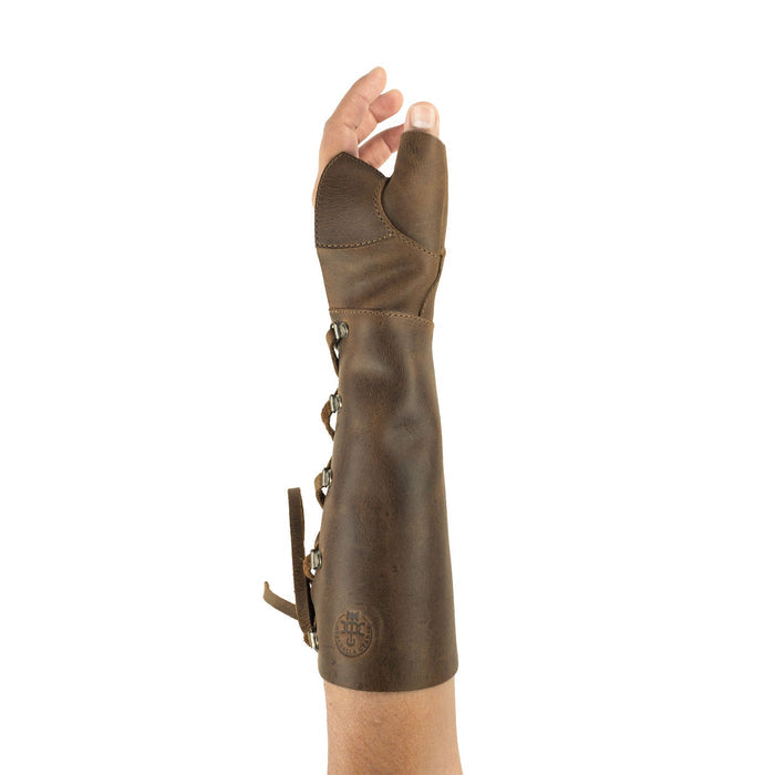 Archery Forearm Protector by Valhalla Gear showing a hand wearing the stylish arm guard, designed for bow shooting practice and training. This Full Grain Leather protector is perfect for cosplay, and reflects the craftsmanship of small batch production, hand cut and sewn, and is fire branded, making it unique and durable. Artisan handmade in La Antigua Guatemala & Oaxaca Mexico.