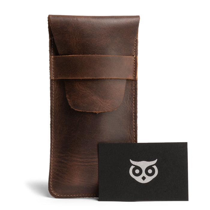 Hide & Drink Cigar Holder presented alongside a branded card, this slim cigar case for three 50 ring cigars showcases a classic design. It features a rustic portable bag made from full grain leather, artisan-made and hand sewn in La Antigua Guatemala, emphasizing quality small batch production.