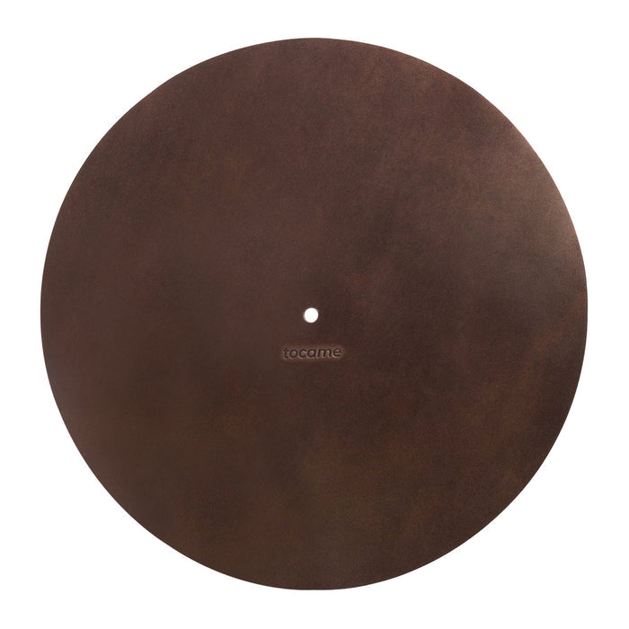 Flat lay of the tocame Circular Turntable Slipmat, highlighting its luxurious full grain leather material. This antistatic cover is perfect for reducing static and dust noise. A hallmark of small batch production and artisan craftsmanship from La Antigua Guatemala.