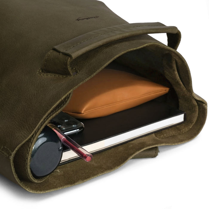 An open view of the Convertible Backpack to Shoulder Bag by Heather's reveals ample storage for daily essentials. This spacious crossbody for women is crafted from high-quality full grain leather, reflecting the values of small batch production and artisan craftsmanship. Handmade in La Antigua Guatemala & Oaxaca Mexico, each bag is uniquely hand cut, hand sewn, and fire branded.