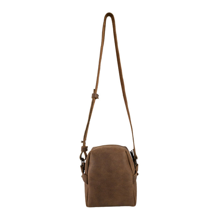 Side view of Heather's Cube Shaped Bag featuring an adjustable shoulder strap. This Cube Shape Bag is a unique Rustic Satchel, ideal as a Handbag or Purse crafted from luxurious Full Grain Leather. It represents StockyardX’s focus on Small Batch Production, showcasing expert Hand Cut and Hand Sewn details, Fire Branded for quality assurance, and is Handmade in La Antigua Guatemala & Oaxaca Mexico.