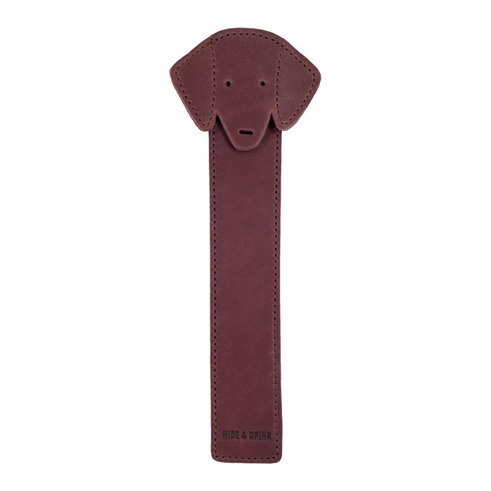 The front view of Hide & Drink's burgundy Dog Bookmark designed in Full Grain Leather, showcasing the unique dog face. This handmade bookmark reflects the quality of small batch production and fire branding, crafted in La Antigua Guatemala & Oaxaca Mexico.
