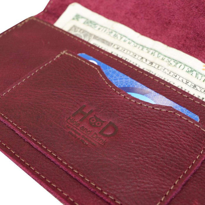 Close-up of the card slot in the Red Double Snap Folio Wallet by Hide & Drink, highlighting the intricate craftsmanship. Made from full grain leather, this wallet serves as an excellent rectangular flat bill holder with card slot and a classy night bag or travel accessory, created in La Antigua Guatemala & Oaxaca Mexico.