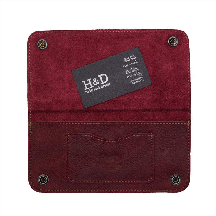Inside view of the Red Double Snap Folio Wallet by Hide & Drink, detailed with a card slot and cash compartment. This full grain leather wallet combines function and style, making it a great rectangular flat bill holder with card slot and travel accessory, handmade in La Antigua Guatemala & Oaxaca Mexico.