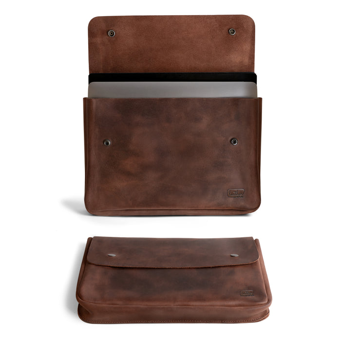 Leather Worx Folder Document Holder showcasing a sleek design, handmade from full grain leather. This vintage folder document holder is perfect for carrying files, serving as a document portfolio and binder strapless carry on bag, ideal for office and work essentials. Crafted with care in La Antigua Guatemala, it reflects small batch production with hand cut and hand sewn techniques, and features fire branded artisan craftsmanship.