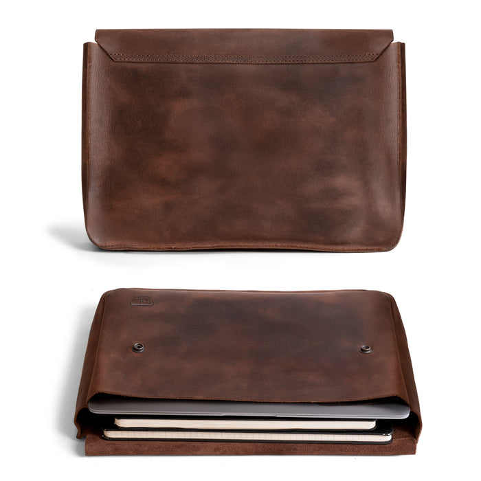 Leather Worx Folder Document Holder displayed in a stylish manner, made from durable full grain leather. This vintage folder document holder functions as a file case, ideal for organizing documents, serving as an office and work essential. Each piece is artisan-crafted in La Antigua Guatemala, showcasing small batch production methods, hand cut and hand sewn details, and fire branded finishing.