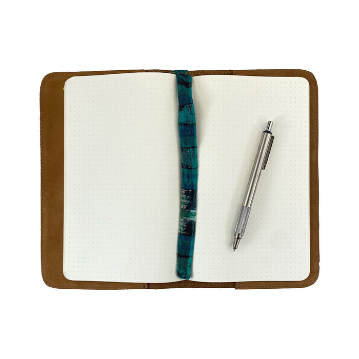 Open view of a brown Journal Cover for Moleskine Cahier L (5 x 8.25 in.) by Hide & Drink, displaying its spacious interior. This refillable journal cover is perfect for large size (5 x 8.25 in.) notebooks, crafted from beautiful full grain leather.