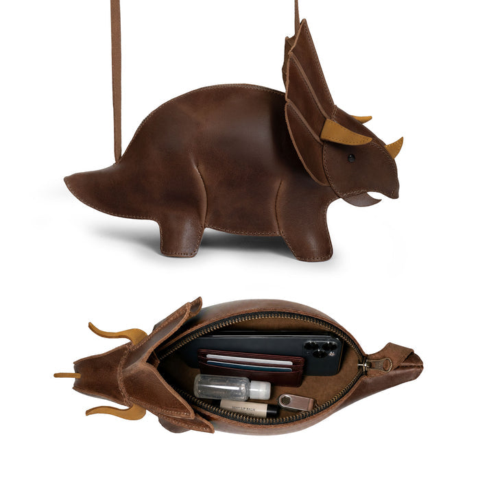 Side view of the Tudi Frudi Leather Dinosaur Triceratops Shoulder Bag, a brown Full Grain Leather dinosaur purse with adjustable strap, reflecting StockyardX Small Batch Production, Hand Cut, Hand Sewn, Fire Branded Artisan craftsmanship, Handmade in La Antigua Guatemala & Oaxaca Mexico.