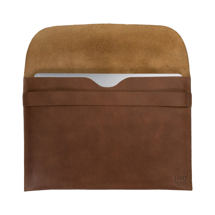 Smooth back view of the brown Hide & Drink MacBook Slim Case, revealing its clean lines and craftsmanship. This case fits MacBook Air/Pro 13 Inch with M1 Chip, emphasizing the artisan quality derived from small batch production and full grain leather.
