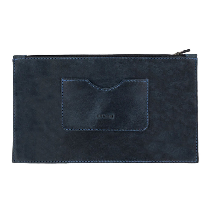 A frontal view of a dark brown rectangular zippered handbag by Hide & Drink emphasizing its elegant design. Perfect for women, this full grain leather female purse includes a card slot, representing artisan craftsmanship through small batch production, handmade in La Antigua Guatemala & Oaxaca Mexico.