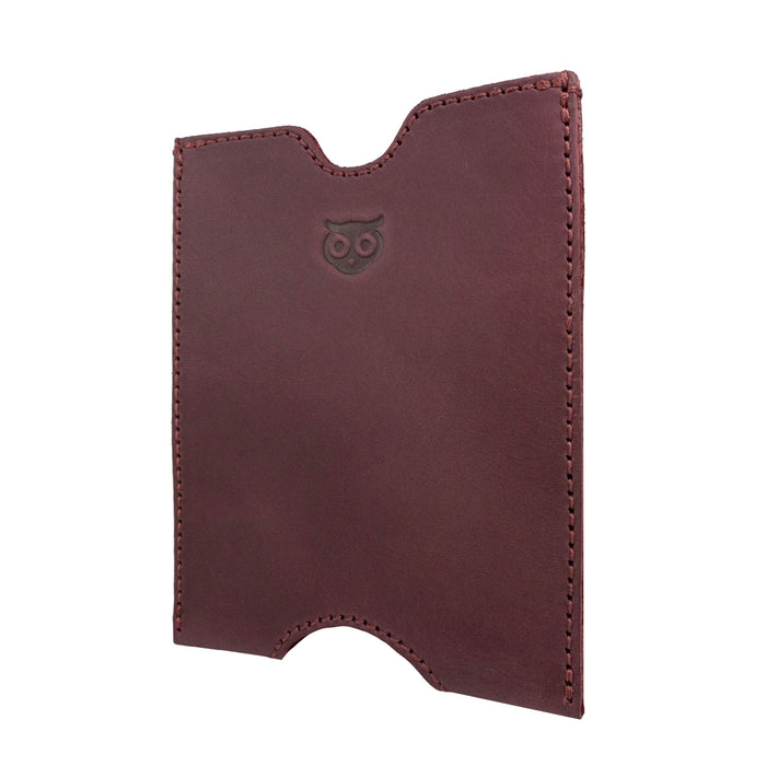 Side angle of the burgundy Hide & Drink Passport Sleeve, highlighting its handcrafted design in Full Grain Leather. This Travel Passport Pocket Sleeve showcases artisan workmanship with details reflecting small batch production, handmade care, and fire branding techniques in La Antigua Guatemala & Oaxaca Mexico.