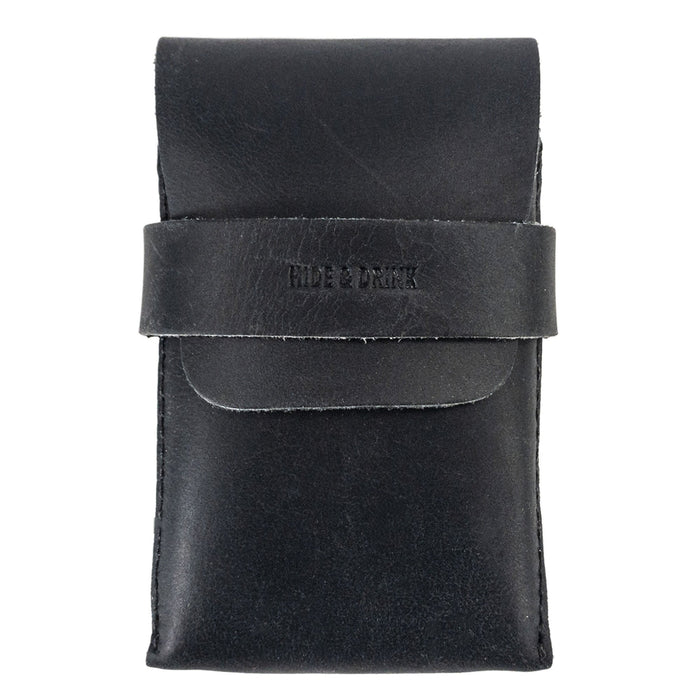 Front view of Hide & Drink's Playing Card Case in black leather. This stylish travel accessory serves as a classic case for playing cards (not included), providing secure storage for game nights. Made from full grain leather, this artisan crafted item is hand cut and sewn, reflecting StockyardX's commitment to quality.