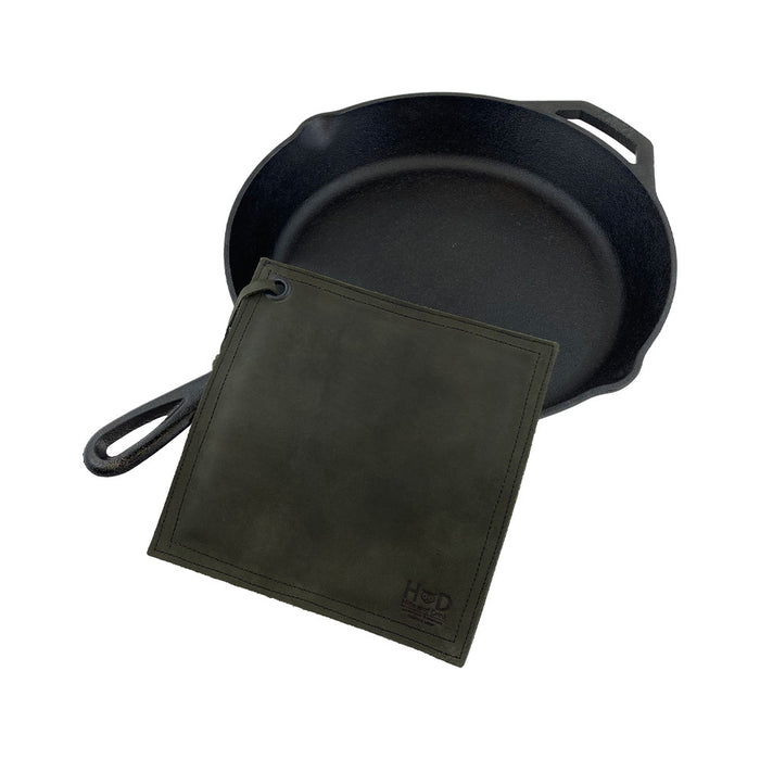 Close-up of the Hide & Drink Pot Pad in rich blue leather. This rustic hot pot pad is perfect for protecting surfaces, crafted with durability in mind.