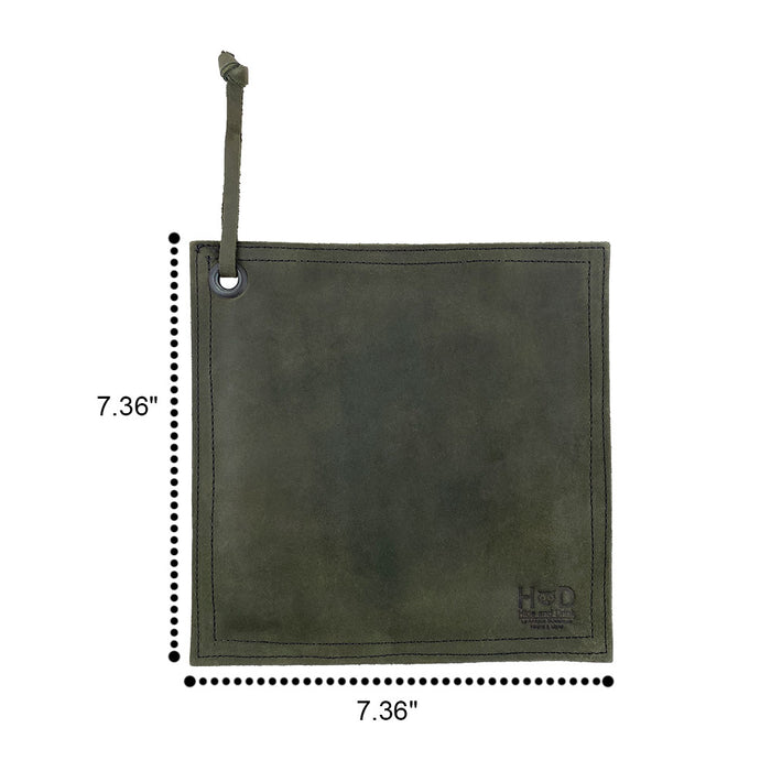 Hide & Drink Pot Pad displayed next to a cast iron pan, showcasing its functionality and design. This artisan pot holder is handcrafted for quality and durability.