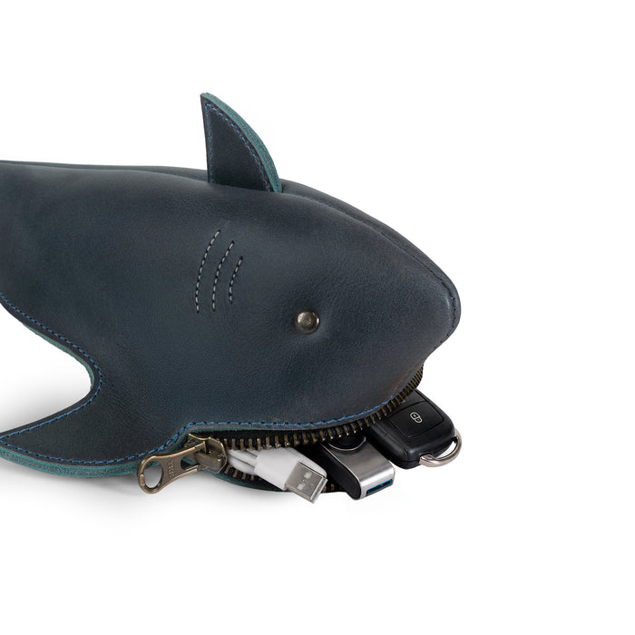 Close-up of the Tudi Frudi Shark Pouch in Full Grain Leather with shark details, brass zipper, car keys, USB drives, and cables; StockyardX Small Batch Production, Hand Cut, Hand Sewn, Fire Branded, Artisan, Handmade in La Antigua Guatemala & Oaxaca Mexico.