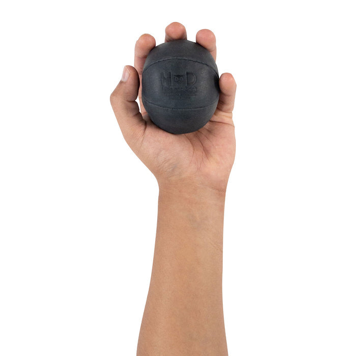 Hide & Drink black Stress Ball held in a hand, perfect for relieving fidgeting and anxiety. This squishy tension accessory features a classic design and is made from full grain leather, artisan crafted in La Antigua Guatemala.