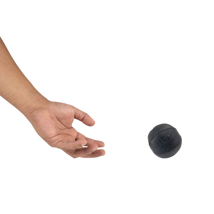 Hide & Drink black Stress Ball released mid-air, ideally suited for relieving fidgeting and anxiety. This squishy tension accessory features classic styling and handcrafted quality from La Antigua Guatemala.