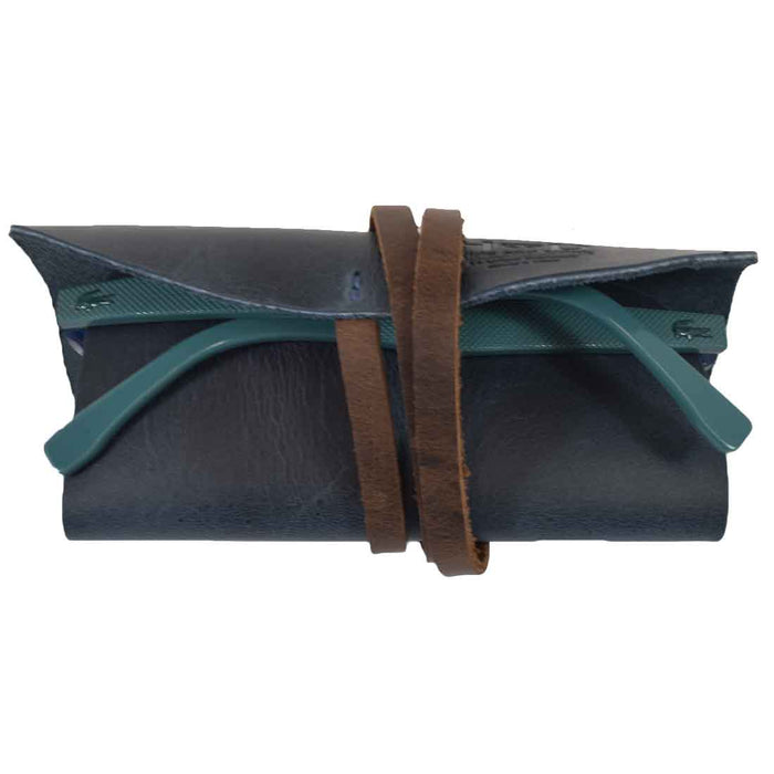 Hide & Drink Sunglass Wrap is an elegant solution for sunglasses storage, crafted from soft full grain leather. This eye glasses storage option is perfect for travel and reflects small batch production with its artisan-made quality.