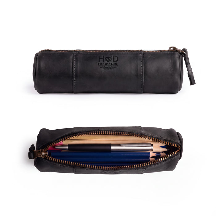 Side view of the Utility Cylinder Case by Hide & Drink highlighting its robust zipper, perfect for securing office supplies or personal items. This classic, handmade bag features Full Grain Leather craftsmanship. Cylinder Case, Handmade, Rustic.