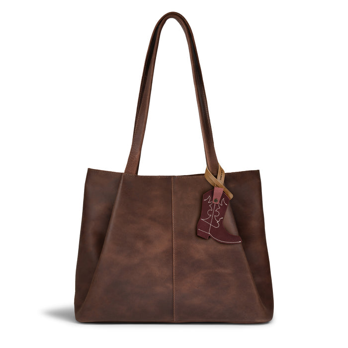 The Western Boot Bag Charm by Hide & Drink adds a stylish touch to your brown leather tote, showcasing the perfect blend of artisan craftsmanship and full grain leather. Ideal as a purse charm or backpack ornament for women, it's handmade in La Antigua, Guatemala & Oaxaca, Mexico, combining small batch production with hand cut and hand sewn details.