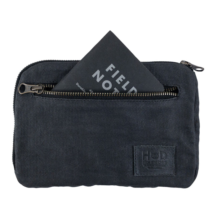 Hide & Drink's dark brown Zipper Gear Pouch featuring a Field Notes card in the front pocket, emphasizing its practical use and artisan quality, made from water resistant waxed canvas.